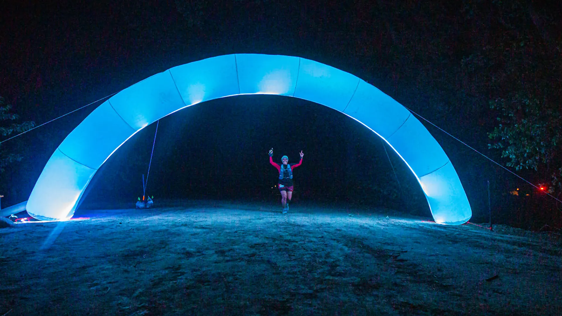 The image shows an illuminated arch-like structure emitting a soft blue light. It appears