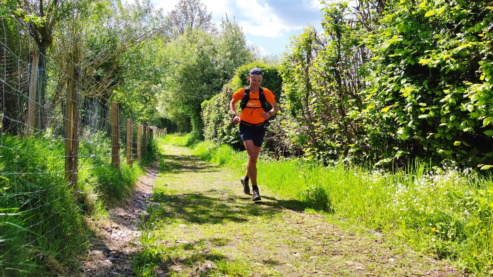 This image features a person who is trail running outdoors. They appear to be wearing