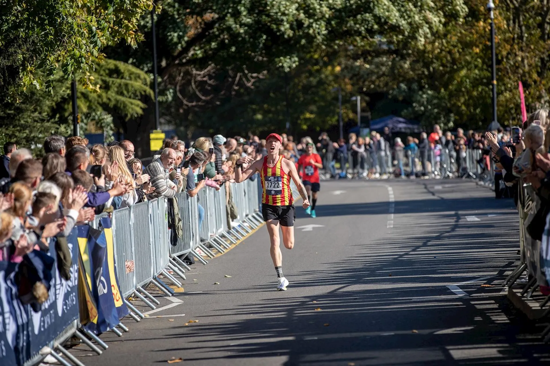 The image shows a road running event, likely a marathon or a race, where