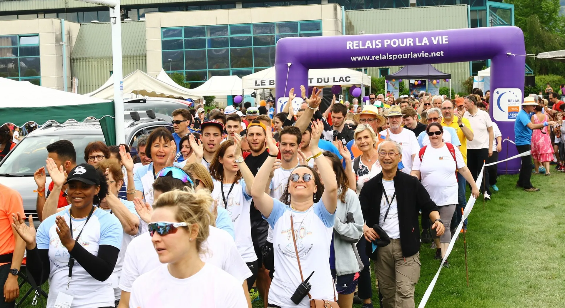 The image shows a group of people participating in a public event or gathering. They