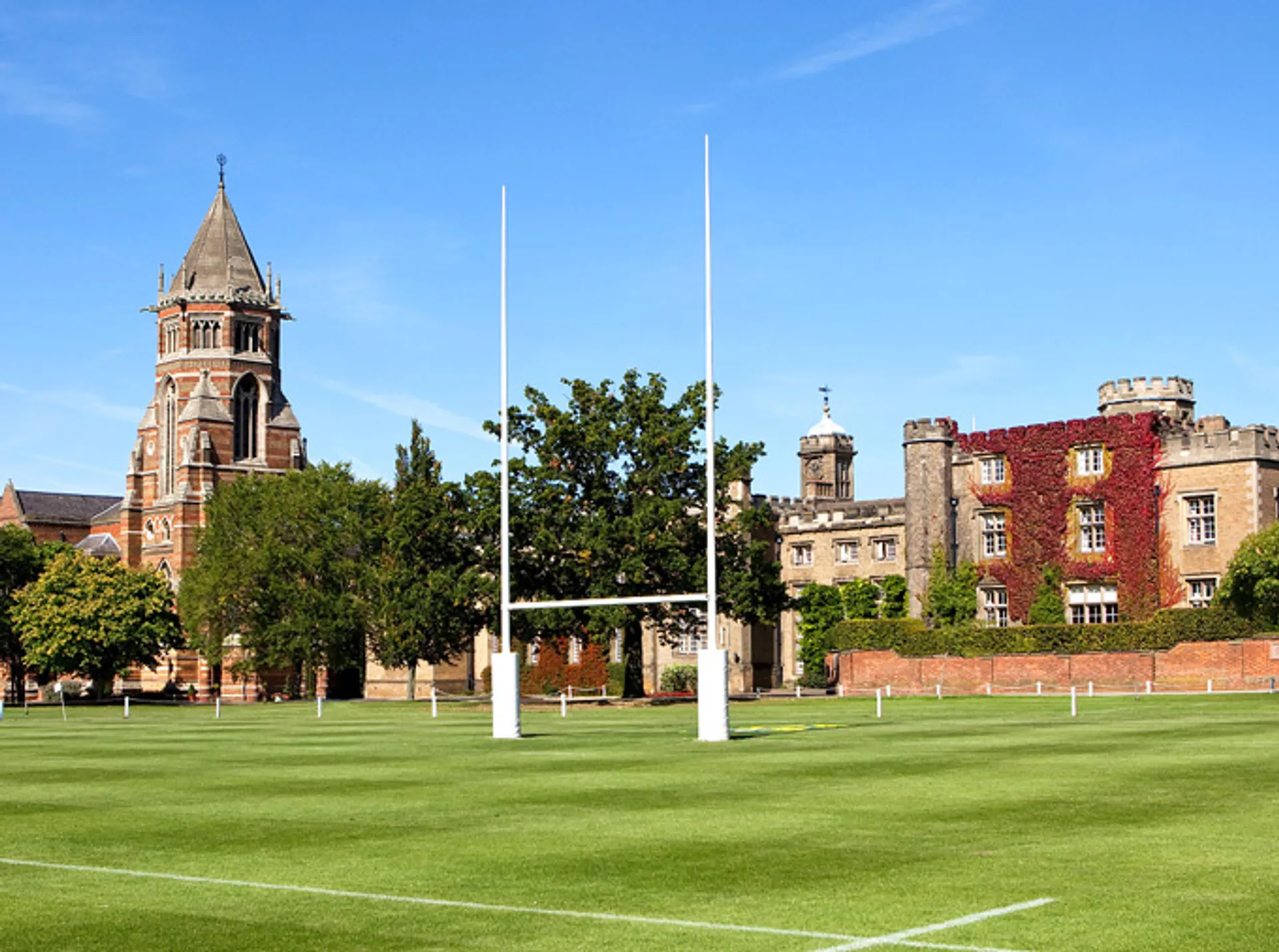 The image shows a well-kept grass sports field with lines marked for a rugby