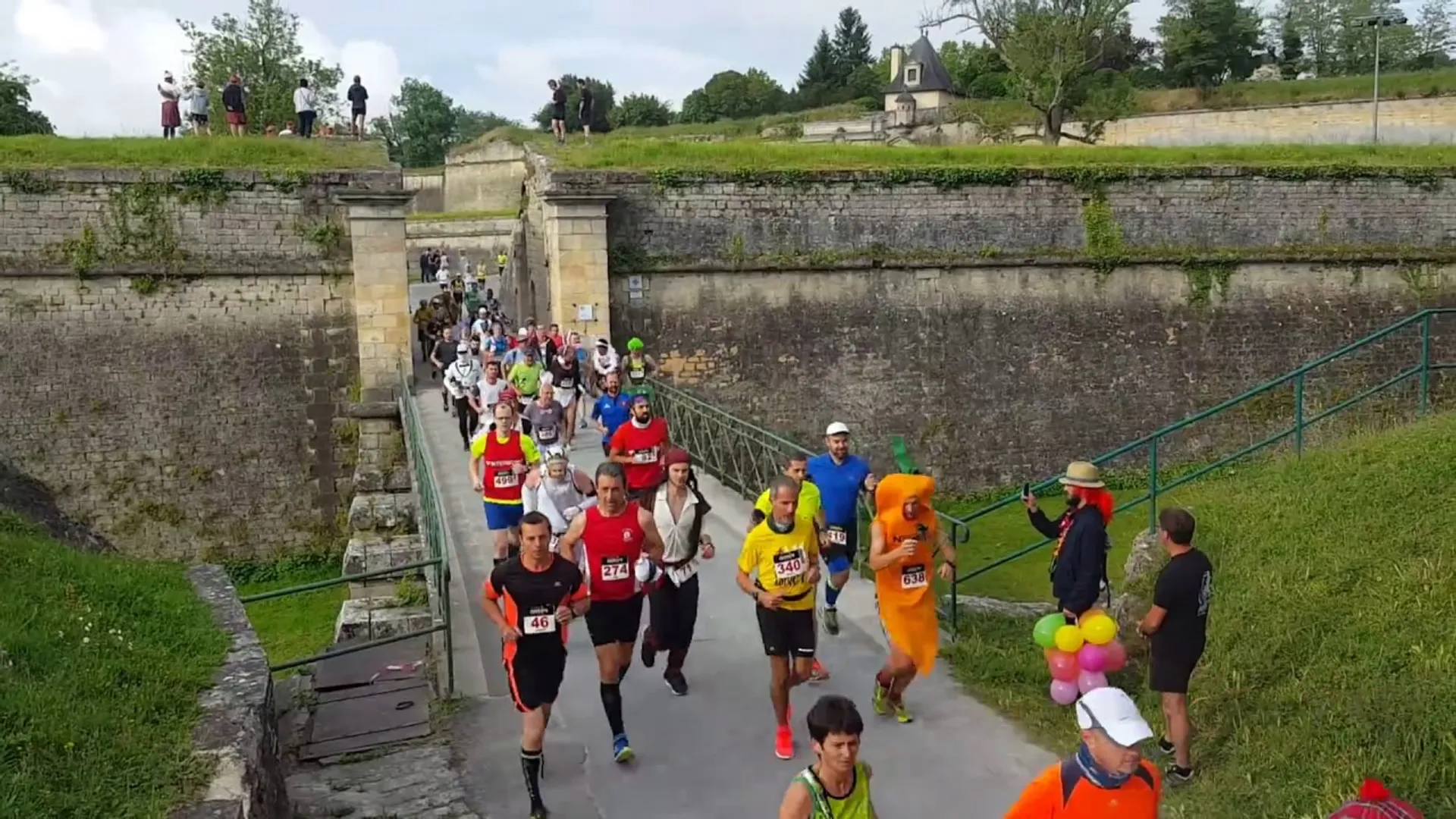 The image shows a group of runners participating in a race or running event. The