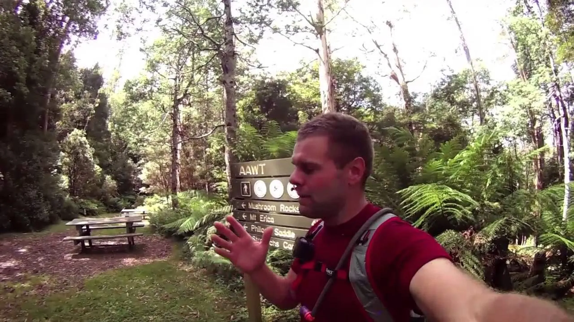 The image shows a person outdoors, seemingly taking a selfie or recording a video.