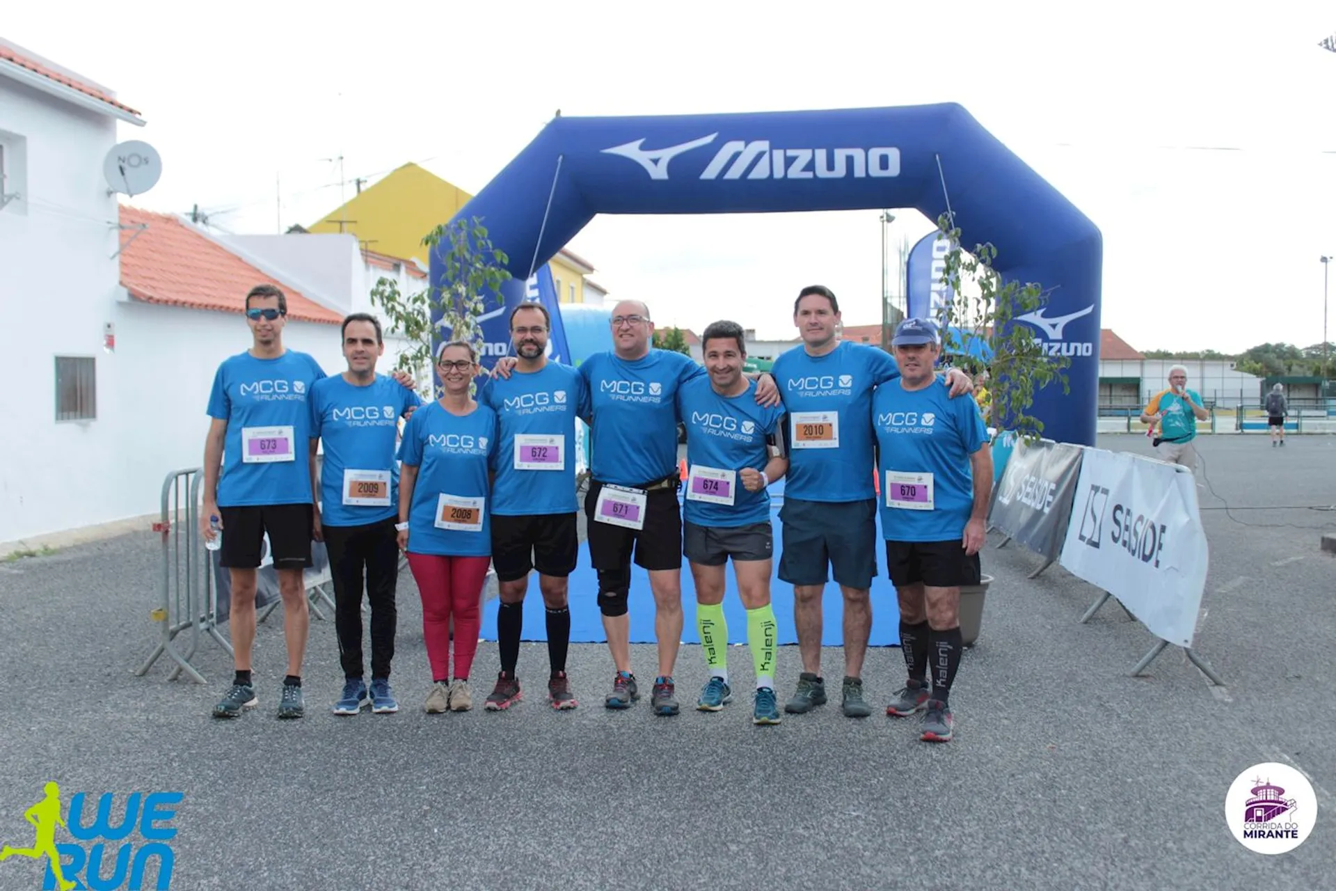 The image shows a group of runners posing together for a photo. They appear to