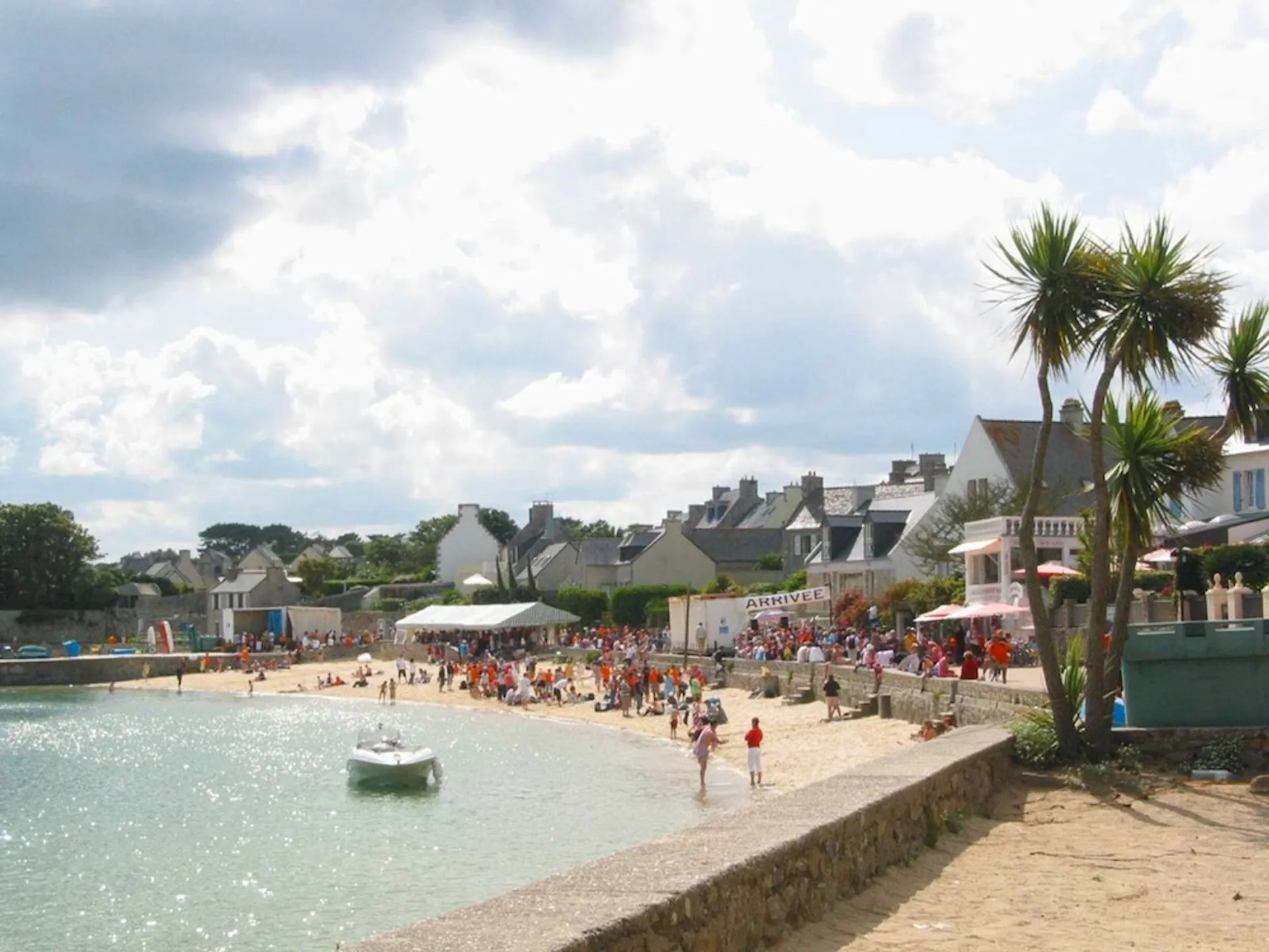 The image shows a sunny beach scene, likely in a coastal town. You can