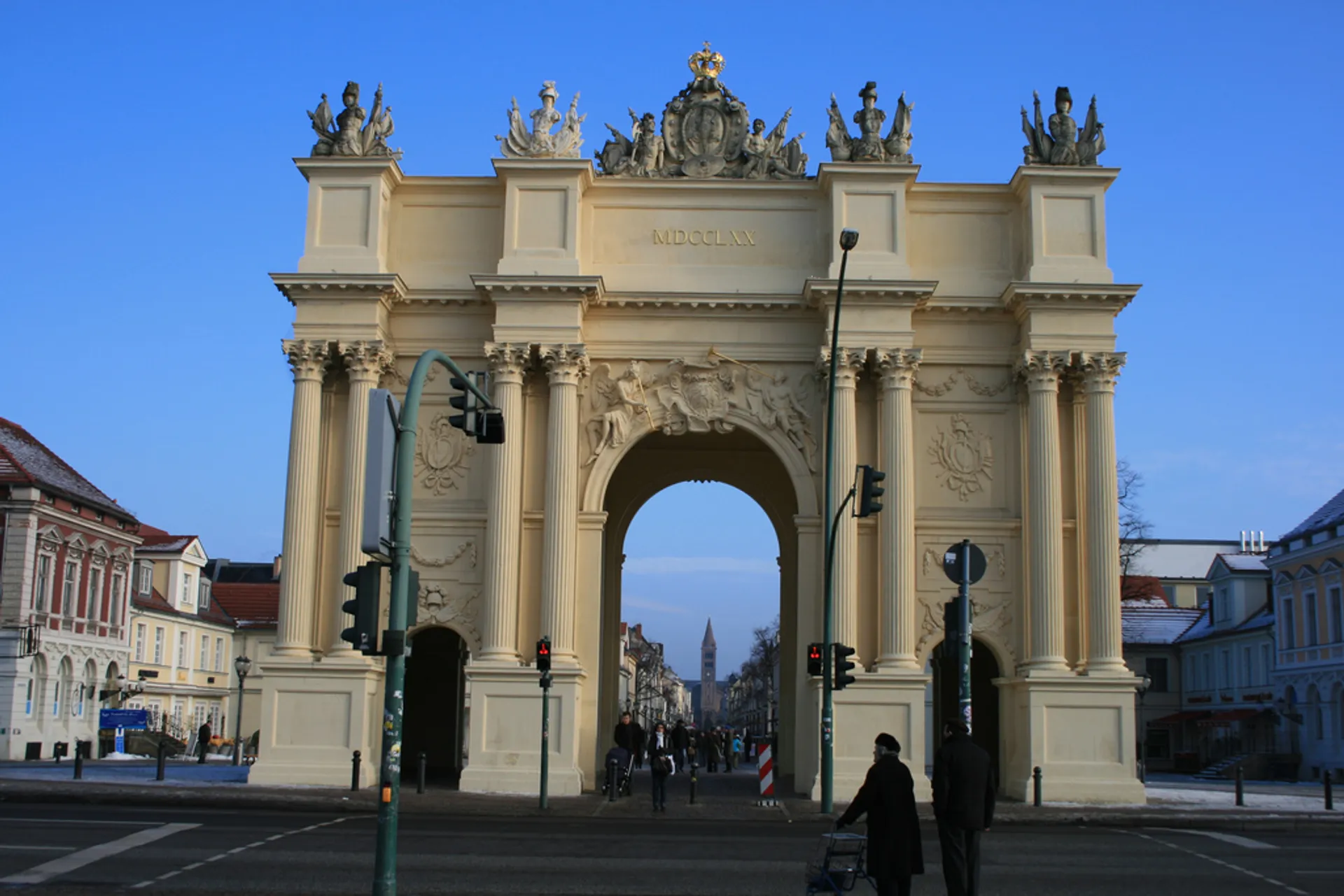 The image shows a large ornate archway with three passageways — a