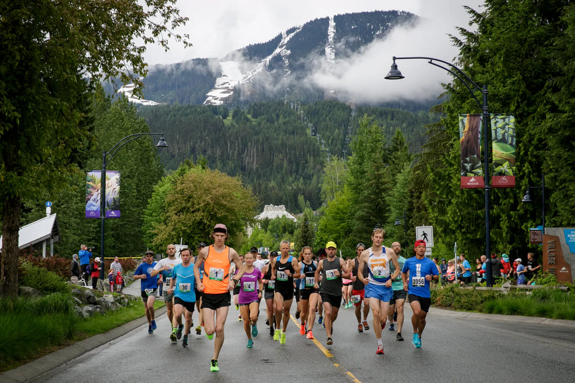 This image shows a group of runners participating in a road race. They appear to