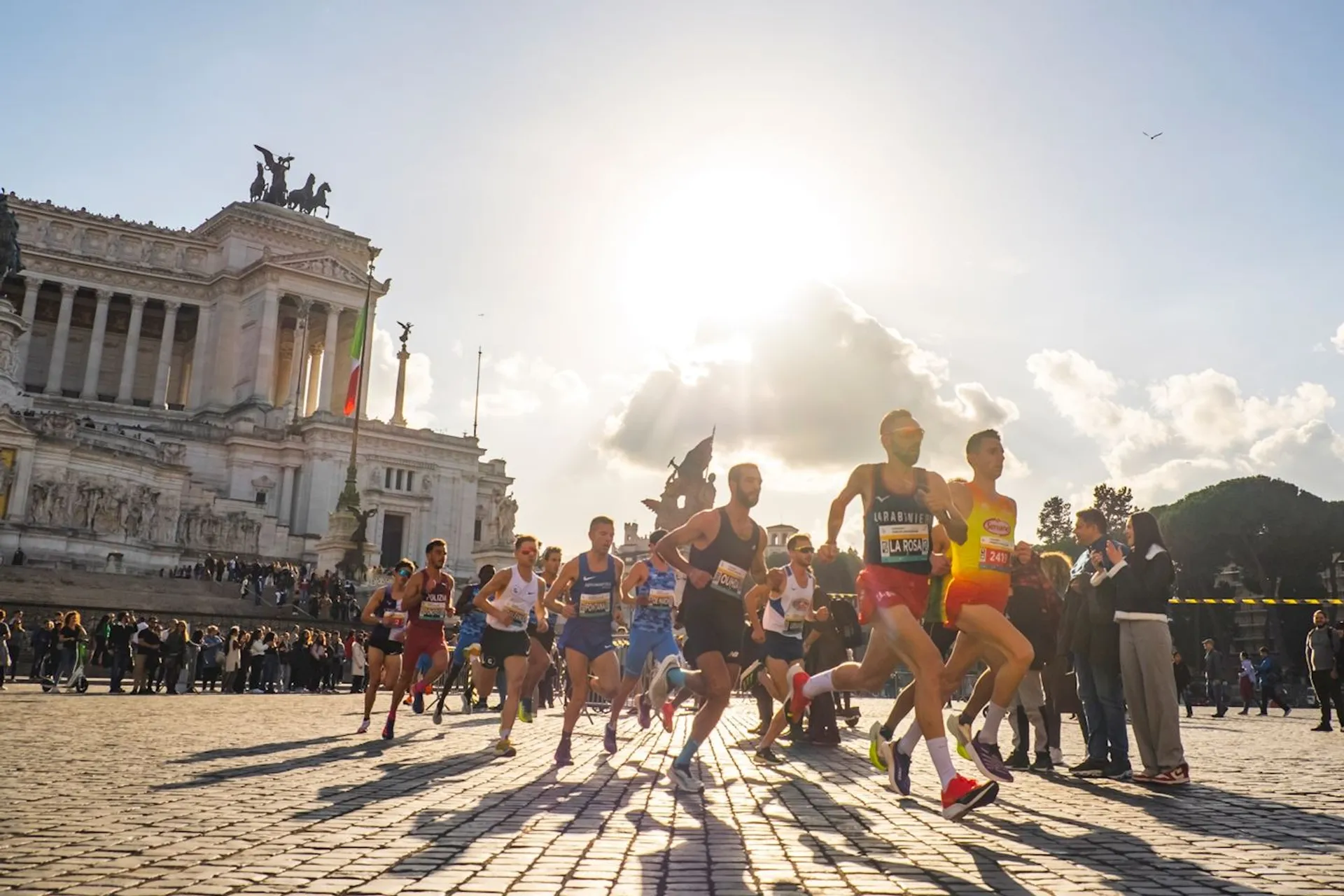 This image shows a group of runners in a road race, likely a marathon or