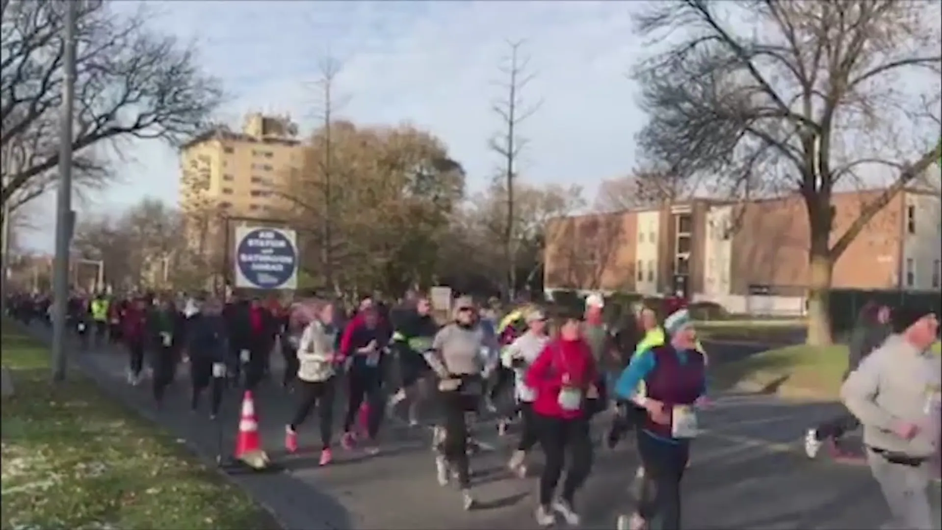 The image shows a group of people participating in a running event. They appear to