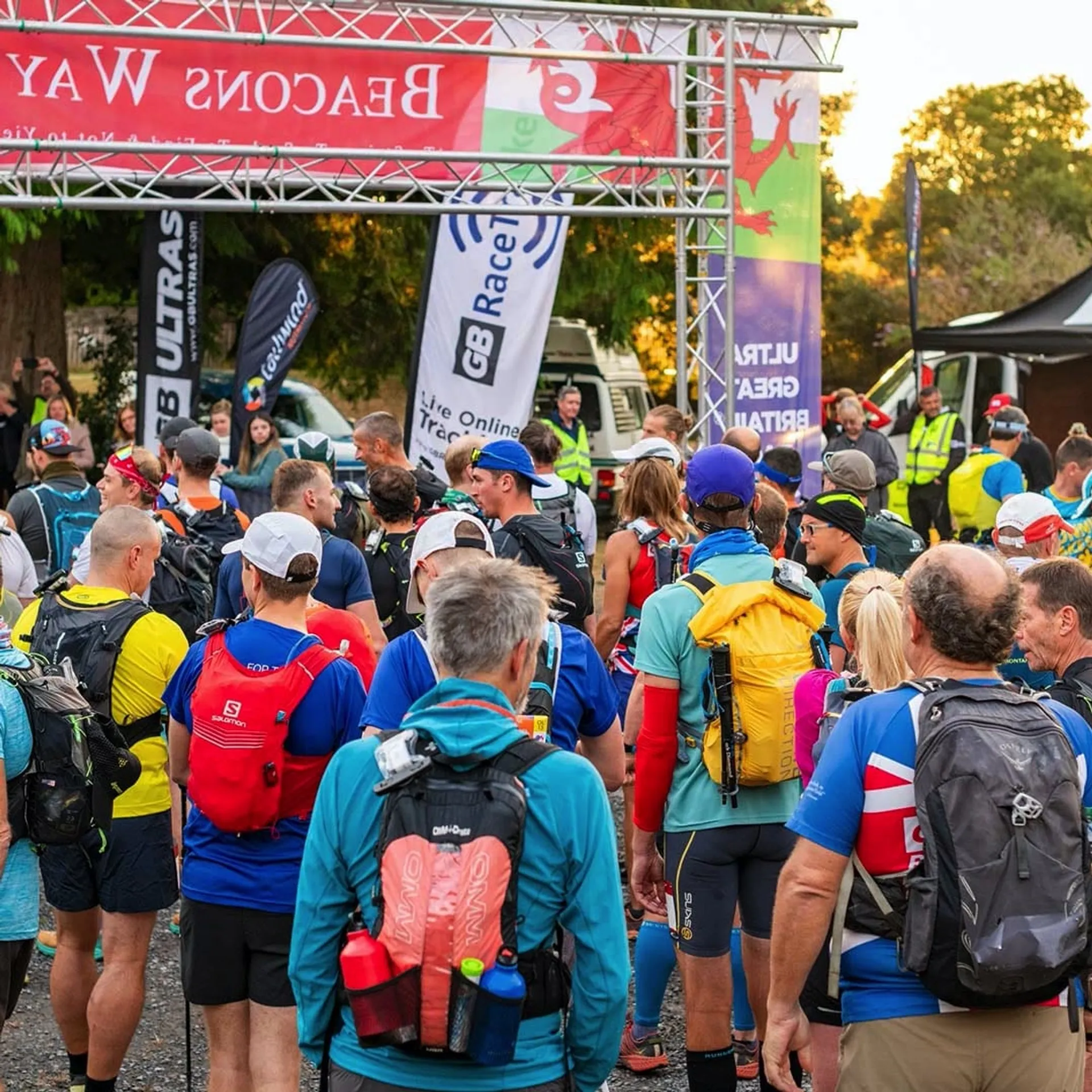 This image shows a group of runners gathering at the starting line of an outdoor race