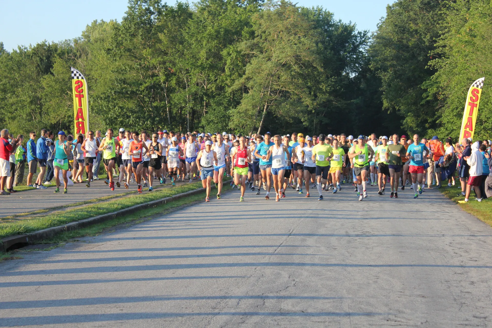 The image shows a group of people participating in a running event or race. They