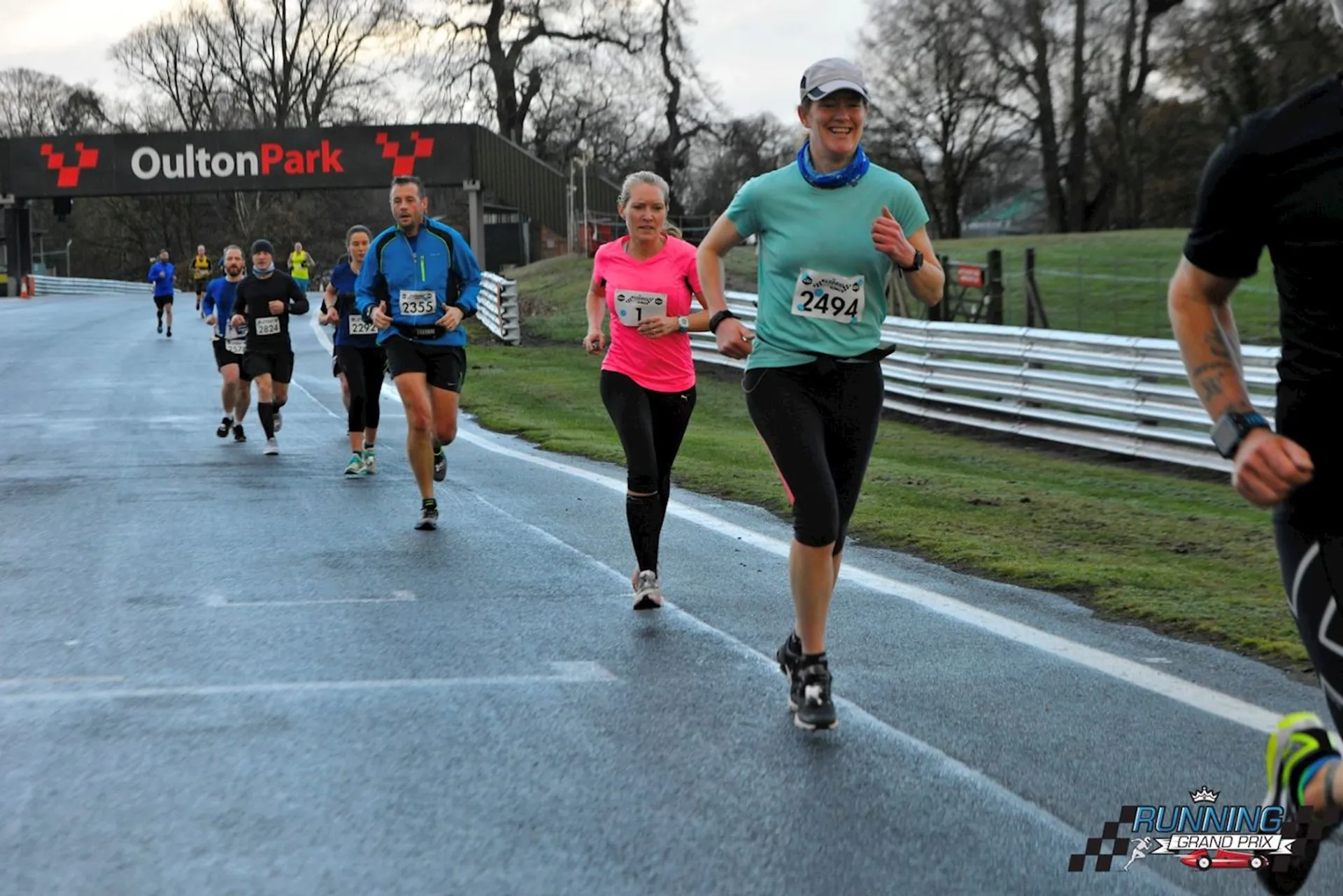 The image shows a group of people participating in a running event at a location named