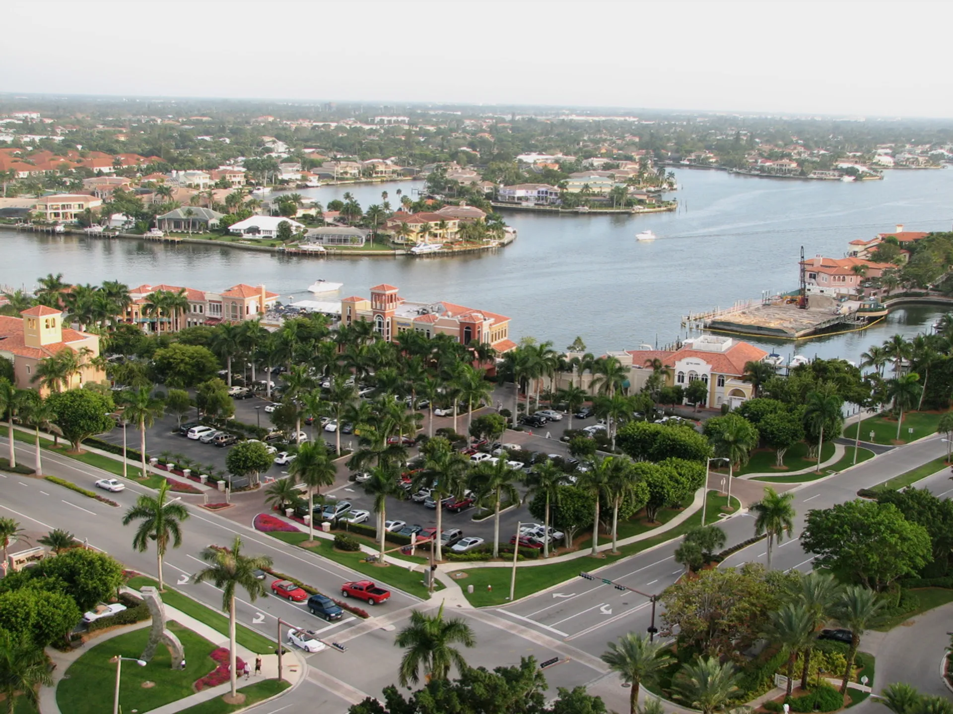 The image shows an aerial view of a coastal area with waterways and residential housing
